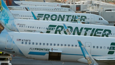 In this June 26, 2019, photo, Frontier Airlines jetliners sit at gates on the A concourse at Denver International Airport.