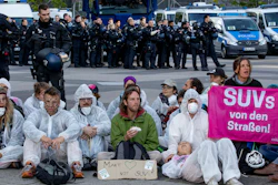 Activists block the main entrance of the fairground in Frankfurt, Sunday, Sept. 15, 2019.