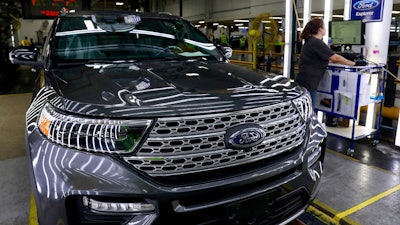 In this June 24, 2019, file photo, employees work on a Ford Explorer line at Ford's Chicago Assembly Plant.