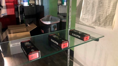 In this Aug. 28, 2019, photo, boxes of what appear to be Kingpen marijuana vape cartridges are displayed in an illegal dispensary in Los Angeles that was shut down by police.