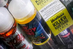 In this Sept. 16, 2019, file photo, flavored vaping solutions are shown in a window display at a vape and smoke shop, in New York.