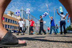 Workers circle the entrance to the Flint Assembly Plant, Thursday, Sept. 19, 2019.