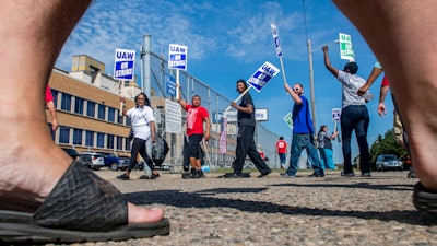 Workers circle the entrance to the Flint Assembly Plant, Thursday, Sept. 19, 2019.