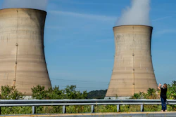 Eileen DeFrancisco of Middletown, Pa., shoots a video of Three Mile Island minutes before the power plant was shut down, Friday, Sept. 20, 2019.