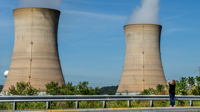 Eileen DeFrancisco of Middletown, Pa., shoots a video of Three Mile Island minutes before the power plant was shut down, Friday, Sept. 20, 2019.
