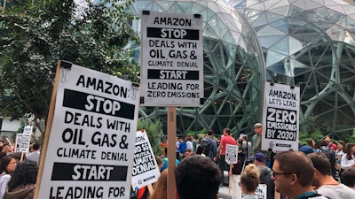 Amazon workers begin to gather in front of the Spheres, Friday, Sept. 20, 2019, in Seattle.
