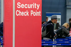 In this March 22, 2016 file photo, passengers check into their flights near a security checkpoint sign at O'Hare International Airport in Chicago.