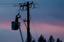 In this Nov. 26, 2018, file photo, a Pacific Gas & Electric lineman works to repair a power line in fire-ravaged Paradise, Calif.