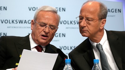 In this March 13, 2014, file photo, then-Volkswagen CEO Martin Winterkorn, left, and then-CFO Hans Dieter Poetsch, right, talk prior to the company's annual press conference in Berlin.