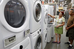 In this Sept. 23, 2019, photo, Maria Alvarez and her husband Guillermo Alvarez examine washers and dryers at a Home Depot location in Boston.