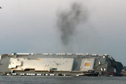 In this Sunday, Sept. 8, 2019, photo, smoke rises from a cargo ship that capsized in the St. Simons Island, Ga., sound.
