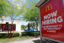 In this Monday, July 1, 2019, file photo, a 'Now Hiring' sign appears on a bus stop in front of a McDonald's restaurant in Miami.