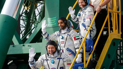United Arab Emirates astronaut Hazza Al Mansouri, center, Russian cosmonaut Oleg Skripochka, bottom, and U.S. astronaut Jessica Meir, top, board the Soyuz MS-15 spacecraft for the launch at the Baikonur cosmodrome, Kazakhstan, Sept. 25, 2019.