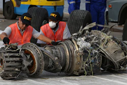 In this Nov. 4, 2018, file photo officials inspect an engine recovered the crashed Lion Air jet in Jakarta.