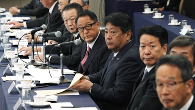 Akio Toyoda, center, president and CEO of Toyota Motor Corp., with a group of the Japanese automakers chiefs attend a meeting with Japanese Trade Minister Isshu Sugawara, not in picture, Sept. 26, 2019, in Tokyo.