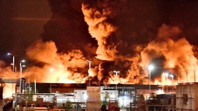 A fire is pictured at a chemical plant in Rouen, Normandy, Thursday, Sept.26, 2019. An immense mass of black smoke is rising over Normandy as firefighters battle a blaze at a chemical plant, and authorities closed schools in 11 surrounding towns and asked residents to stay indoors.