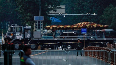 In this Saturday, Sept. 21, 2019, photo, a Chinese military vehicle possibly carrying a drone passes along the Jianguomenwai Avenue during a rehearsal for the 70th anniversary of Communist China, in Beijing. A parade on Tuesday, Oct. 1 by China’s secretive military will offer a rare look at its rapidly developing arsenal, including possibly a nuclear-armed missile that could reach the United States in 30 minutes, as Beijing gets closer to matching Washington and other powers in weapons technology.