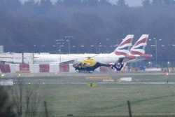 A police helicopter flies over Gatwick Airport after drones were spotted over the airfield, Dec. 20, 2018.