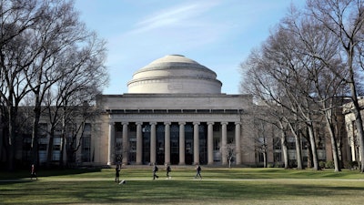 In this April 3, 2017 file photo, students walk past the 'Great Dome' atop Building 10 on the Massachusetts Institute of Technology campus in Cambridge, Mass. MIT said Media Lab director Joi Ito resigned Saturday, Sept. 7, 2019, after reports he had a more extensive fundraising relationship with disgraced financier Jeffrey Epstein than previously acknowledged.