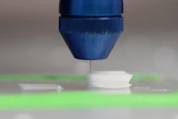 Printer head on a solvent-cast 3D printer depositing the functionalized polymer inks layer-by-layer from a needle. The solvent evaporates, leaving behind a solid 3D-printed polymer fiber.