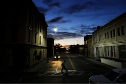 In this Oct. 28, 2017, file photo a pedestrian crosses a downtown street at dusk in Lumberton, N.C. Small and mid-sized businesses are having a harder time getting credit and that’s having an impact on their plans to hire. Those are findings of a quarterly survey of small businesses released Monday by Pepperdine University’s Graziadio School of Business and Management and Dun & Bradstreet Corp.