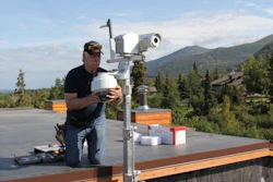 John Parker installs a new wildfire monitoring system on the roof of an Anchorage home. The Anchorage Fire Department hopes it will help them spot wildfires faster.