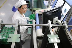 In this Aug. 27, 2019, photo, an employee works on the production line of a smart electricity meter manufacturing plant in Nantong in eastern China's Jiangsu province. Two surveys of Chinese manufacturing show demand is weak amid a mounting tariff war with Washington over trade and technology.
