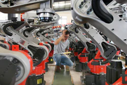 In this Wednesday, Sept. 11, 2019, photo, a man checks on the robotic arms at a factory making industrial robots in Zhengyu town of Haimen city in east China's Jiangsu province. A Chinese envoy is going to Washington on Wednesday, Sept. 18, to prepare for trade negotiations. The announcement Tuesday, Sept. 17, follows conciliatory gestures by both sides ahead of the October talks on their fight over trade and technology, which threatens to dampen global economic growth.