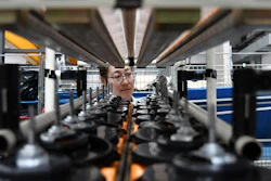 In this May 15, 2019, file photo, a factory worker checks parts at a manufacturing plant for automobile air conditioners in Yantai in eastern China's Shandong province. Two gauges of Chinese factory activity improved in September ahead of talks with Washington aimed at ending a tariff war, according to survey released Monday, Sept. 30, 2019.