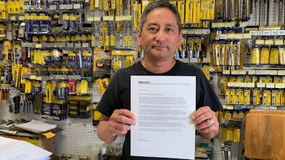 In this photo taken Wednesday, Aug. 28, 2019, Albert Chow, owner of Great Wall Hardware in San Francisco, holds a May 2019 letter from a supplier notifying him that prices will be increasing 10 to 18 percent because of US tariffs on Chinese goods. He says he has no choice but to raise store prices on those products.