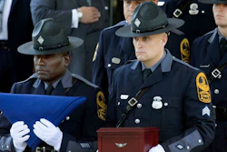 Virginia State Police carry a flag and remains of Trooper Berke Bates, who was killed in a helicopter crash during protests in Charlottesville, Va., at his funeral, Aug. 18, 2017.