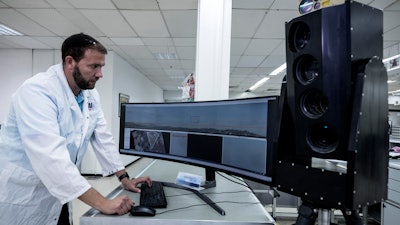 In this Monday, Sept. 9, 2019 photo, Ariel Gomez, a systems engineer at Israel Aerospace Industries, works on the Popstar system that can track and identify flying objects day or night without being detected, at Israel Aerospace Industries, in the Israeli town of Yehud near Tel Aviv. Israel has long been a dominant player in the military drone export business, developing small attack aircraft as well as long-range spy planes. Now, Israeli firms are at the forefront of a global industry developing means to protect against the drone threat.