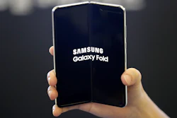 In this Sept. 6, 2019, file photo an employee holds the Samsung Electronics Co.'s Galaxy Fold for a photograph at a shopping mall in Seoul, South Korea. Samsung’s folding phone is finally hitting the U.S. Samsung will start selling the Galaxy Fold, a phone with a screen that folds together like a book, on Friday, Sept. 27.