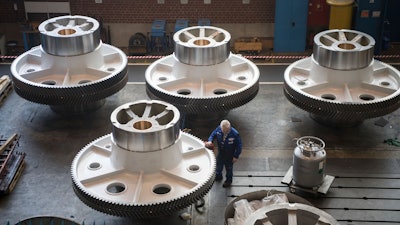 In this March 2, 2018 file photo, a worker cleans big machine parts of presses manufacturer Schüler AG in Goeppingen, Germany. German factory orders, a leading indicator of the health of Europe's biggest economy, dropped strongly in July, erasing gains from the previous month. The Federal Statistical Office reported Thursday industrial orders dropped 2.7% in July over June when adjusted for seasonal and calendar factors, wiping out a 2.7% June increase.