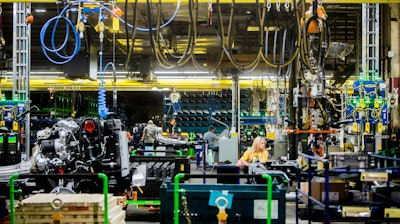 In this June 12, 2019, file photo General Motors employees work on the chassis line as they build the frame, power train and suspension onto the truck's body at the Flint Assembly Plant in Flint, Mich. On Tuesday, Sept. 3, the Institute for Supply Management, a trade group of purchasing managers, issues its index of manufacturing activity for August.