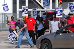 Gary Allison, left, waves while standing with other union members picketing outside the General Motors Plant in Arlington, Texas, Monday, Sept. 16, 2019. More than 49,000 members of the United Auto Workers walked off General Motors factory floors or set up picket lines as contract talks with the company deteriorated into a strike.