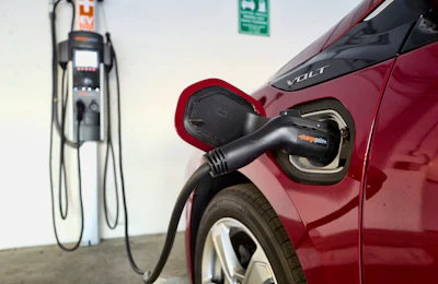 This Wednesday, Oct. 17, 2018 file photo shows a Chevrolet Volt hybrid car charging at a ChargePoint charging station at a parking garage in Los Angeles. If U.S. consumers ever ditch fuel burners for electric vehicles, then the United Auto Workers union is in trouble. Gone would be thousands of jobs at engine and transmission plants across the industrial Midwest, replaced by smaller workforces at squeaky-clean mostly automated factories that mix up chemicals to make batteries.