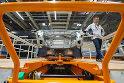 In this Tuesday, May 14, 2019 file photo, Heiko Roesch, head of body construction, walks besides the new electric 'ID.3' car body during a press tour at the plant of the German manufacturer Volkswagen AG (VW) in Zwickau, Germany. Volkswagen is rolling out what it bills as the breakthrough electric car for the masses, the leading edge of a wave of new battery-powered vehicles about to hit the European auto market. The ID.3 is going on display ahead of the Frankfurt Motor Show on Monday Sept. 9, 2019.