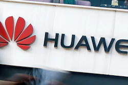 In this July 30, 2019, file photo a woman walks by a Huawei retail store in Beijing. Chinese tech giant Huawei has accused U.S. authorities of trying to coerce employees to gather information on the company and of trying to break into its information systems. The company, the target of U.S. accusations that it is a security threat, said Wednesday, Sept. 4, that American officials were using 'unscrupulous means' to disrupt its business.