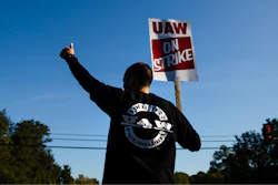 A worker gives the thumbs-up gesture to a passing motorist as he demonstratives outside a General Motors facility in Langhorne, Pa., Tuesday, Sept. 17, 2019. More than 49,000 members of the United Auto Workers walked off General Motors factory floors or set up picket lines early Monday as contract talks with the company deteriorated into a strike.