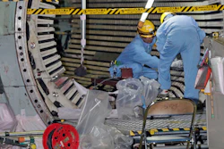 In this Nov. 28, 2018, photo, workers dismantle the Unit 2 reactor at Chubu Electric Power Co.,'s Hamaoka nuclear power plant in Omaezaki, Shizuoka prefecture. Japan's nuclear policy-setting body has adopted a report saying the country is entering an era of massive nuclear plant decommissioning, urging operators to plan ahead to lower safety risks and costs on work requiring decades and billions of dollars.