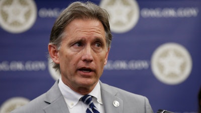 In this Thursday, Sept. 12, 2019 file photo, Oklahoma Attorney General Mike Hunter speaks during a news conference in Oklahoma City. Consumer products giant Johnson & Johnson is appealing an Oklahoma judge's $572 million order against the company and its subsidiaries for helping fuel the state's opioid crisis. The company filed an appeal with the Oklahoma Supreme Court on Wednesday, Sept. 25 arguing the ruling was an 'unprecedented interpretation of Oklahoma public nuisance law.' A spokesman for Hunter said their office is reviewing the appeal.