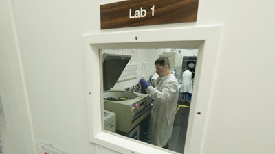 Researchers work at Flora Research Laboratories in Grants Pass, Ore., on July 18, 2019. The Associated Press commissioned the lab to test vape products as part of an investigation that shows a dark side to the booming industry selling the cannabis extract CBD. The lab tested 30 vape products sold around the country as CBD that AP chose by targeting brands that law enforcement authorities or users flagged as suspect. Ten of the 30 samples contained synthetic marijuana, a street drug commonly known as K2 or spice.