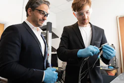 Gleb Yushin, a professor in Georgia Tech's School of Materials Science and Engineering and Kostiantyn Turcheniuk, research scientist in Yushin's lab, inspect a battery using a new cathode design that replaces expensive metals and traditional liquid electrolyte with lower cost transition metal fluorides and a solid polymer electrolyte. The research was funded by the U.S. Army.