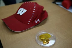 The device, right, is shown along with a baseball cap used to cover it.