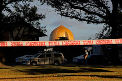 In this March 17, 2019, file photo a police officer stands guard in front of the Masjid Al Noor mosque in Christchurch, New Zealand, where one of two mass shootings occurred. Facebook will work with law enforcement organizations to train its machine learning technology to recognize videos of violent events as part of a broader effort to crack down on extremism. The move comes after its artificial intelligence did not detect the first-person video of a terrorist attack on the mosque in Christchurch.