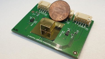 The miniature all-metamaterial optical gas sensor (golden capsule) next to a one-cent coin.