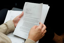 A member of the audience holds a copy of the Whistle-Blower Complaint letter sent to Senate and House Intelligence Committees during testimony by Acting Director of National Intelligence Joseph Maguire before the House Intelligence Committee on Capitol Hill in Washington, Thursday, Sept. 26, 2019.