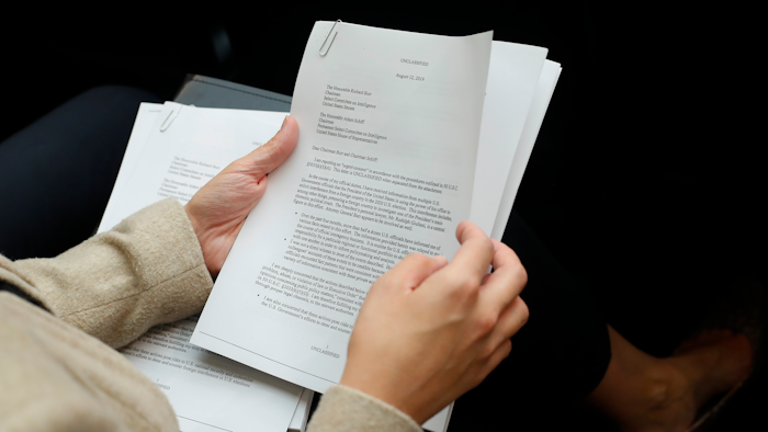 A member of the audience holds a copy of the Whistle-Blower Complaint letter sent to Senate and House Intelligence Committees during testimony by Acting Director of National Intelligence Joseph Maguire before the House Intelligence Committee on Capitol Hill in Washington, Thursday, Sept. 26, 2019.