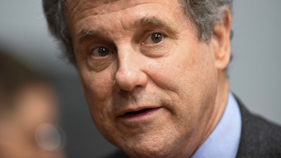 In this March 3, 2019 file photo, Sen. Sherrod Brown, D-Ohio, speaks to reporters during the Martin Luther and Coretta Scott King Unity Breakfast in Selma, Ala. Brown is rolling out a proposal that would force employers to warn workers and retrain them when their jobs are about to be eliminated by automation.